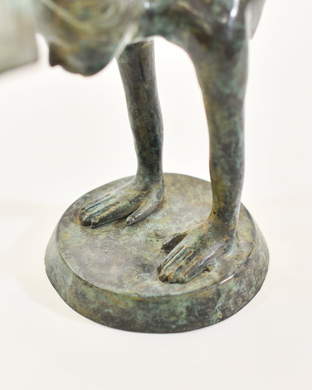 Bronze sculpture of a mermaid on a round base