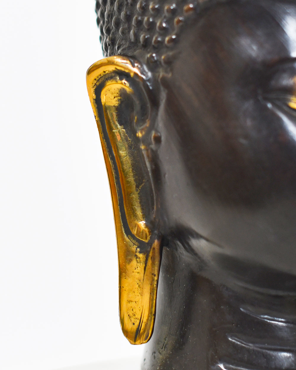 Close Up Of the Brass Highligts From The Bronze Zenith Buddha Bust