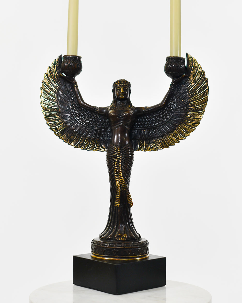 Decorative winged statue holding candles