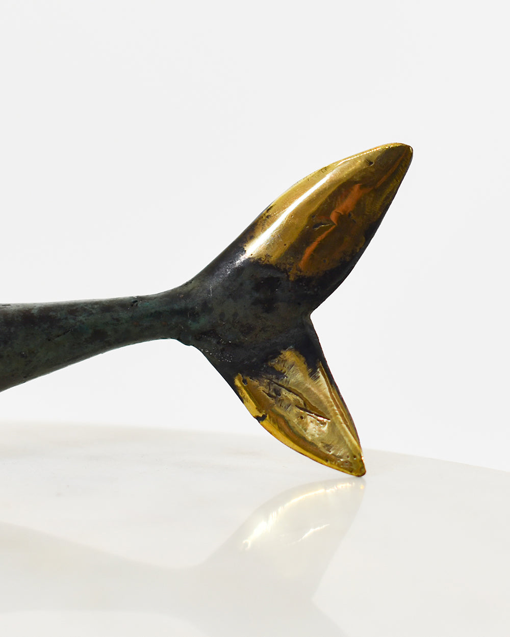 Close Up Of The Brass Hues On The Shark Decoration